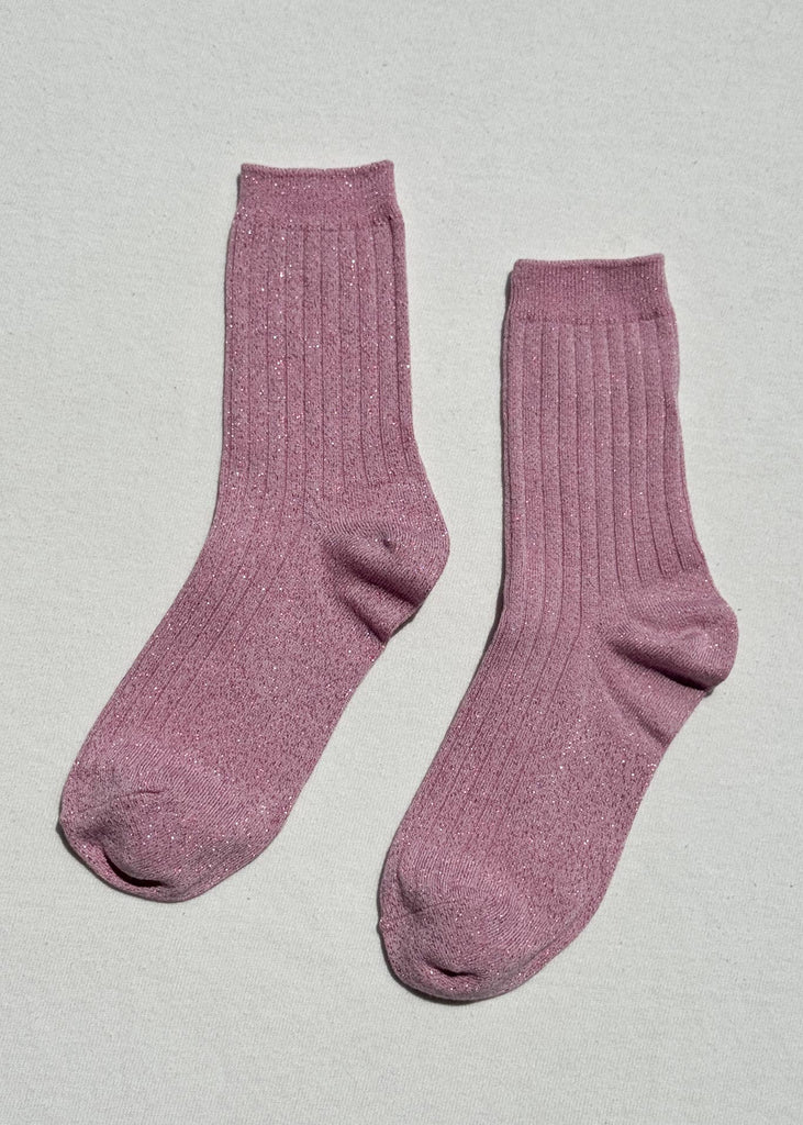 Pair of pink socks on a light gray background