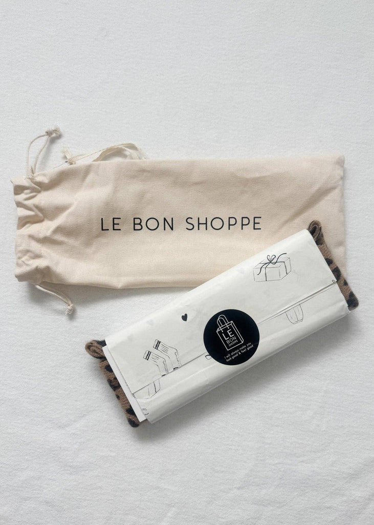 Product packaging with 'LE BON SHOPPE' drawstring bag on a light gray background