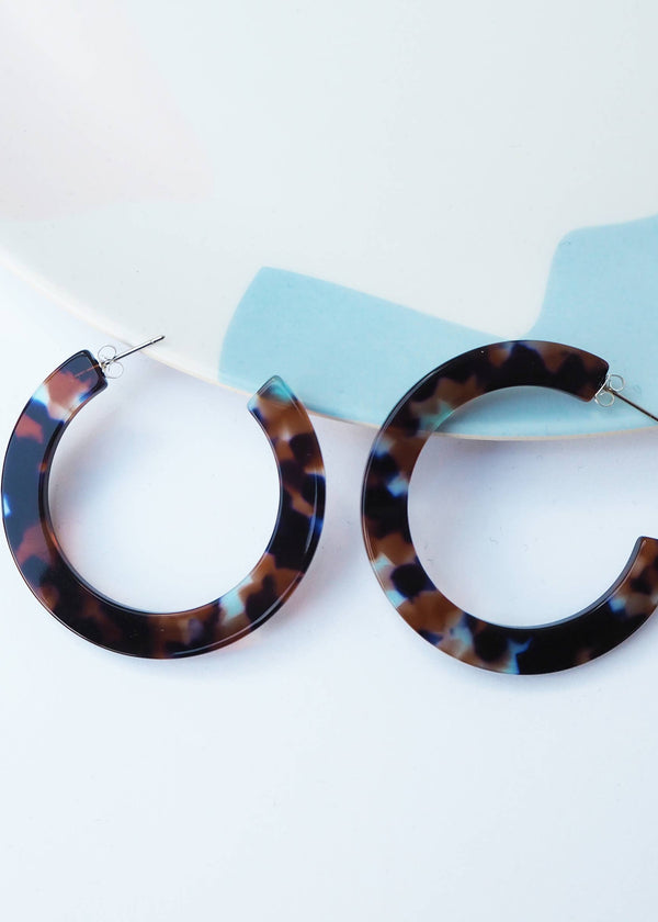 Tortoiseshell hoop earrings on a white background