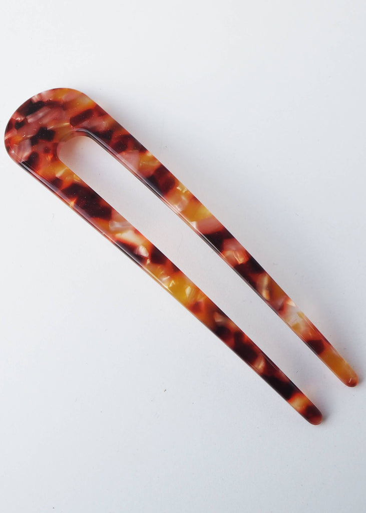 Tortoiseshell patterned hair clip on a white background