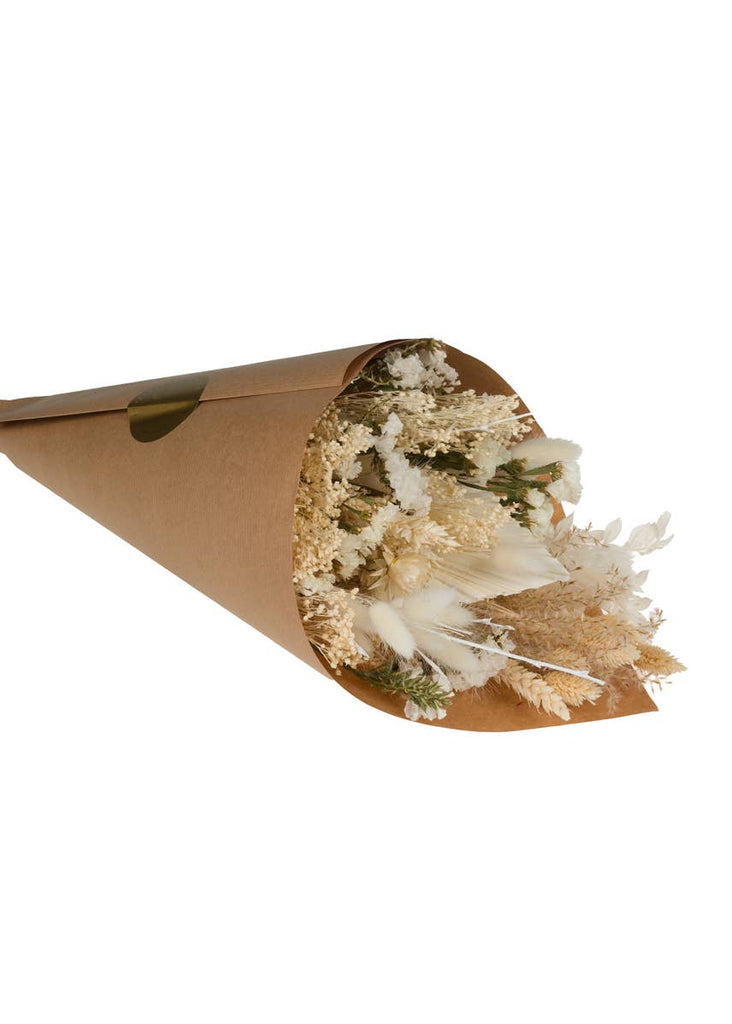 Bouquet of dried flowers wrapped in brown paper on a white background
