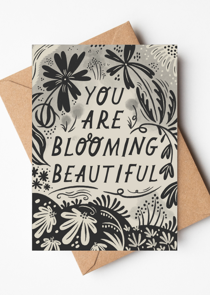 Greeting card with floral design and text 'You are blooming beautiful' on a white background