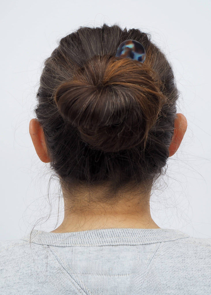 Back view of a person with a bun hairstyle on a white background