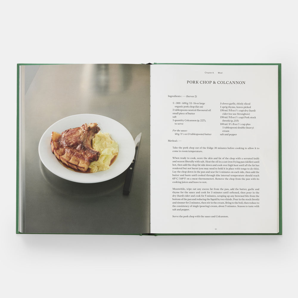 Open cookbook showing a plate of pork chop and colcannon with text on a white background