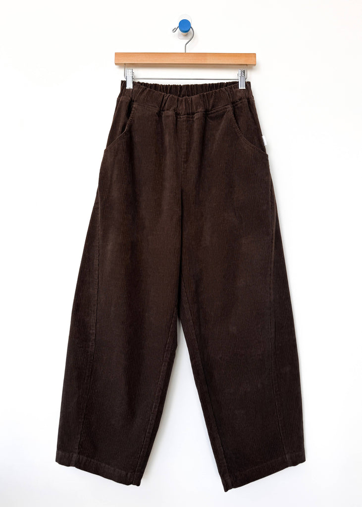 Brown wide-leg pants on a hanger against a white background