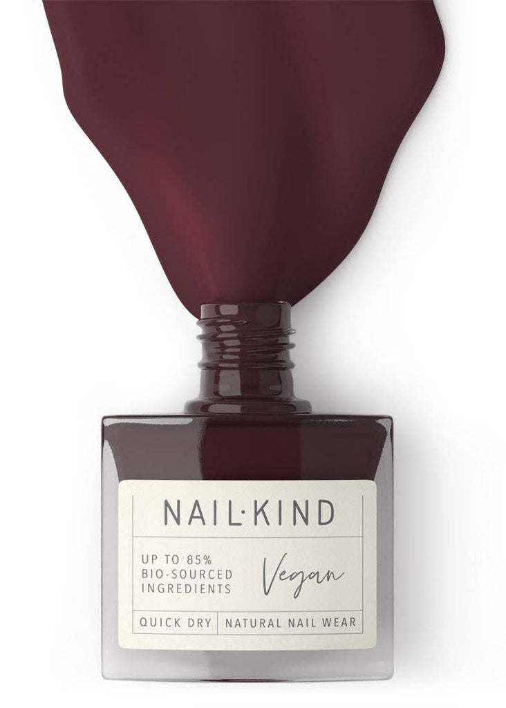 Nail polish bottle with 'Nail-Kind' label on a white background