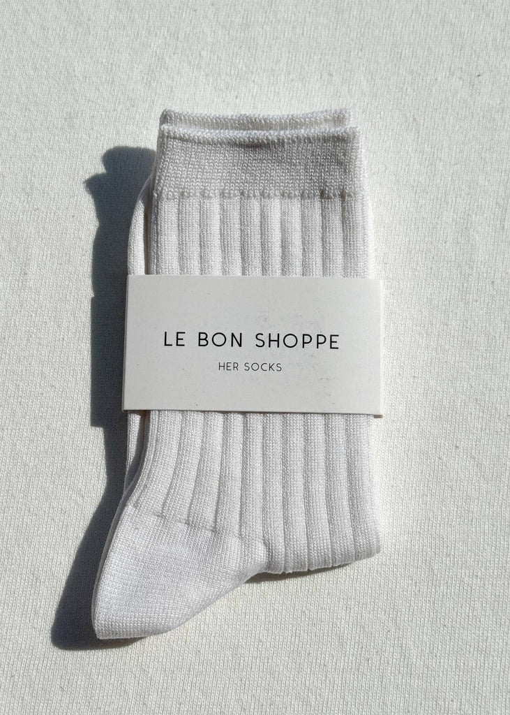 Gray socks with a 'Le Bon Shoppe' label on a light gray background
