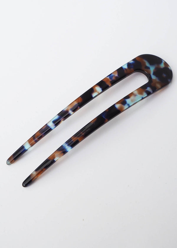 Tortoiseshell patterned hair clip on a white background