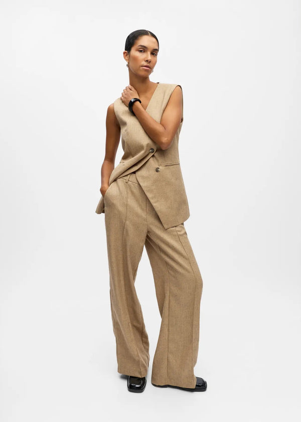 Woman wearing a beige suit on a white background