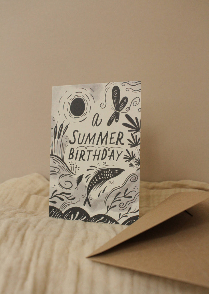 Greeting card with 'A Summer Birthday' text and decorative elements on a beige background