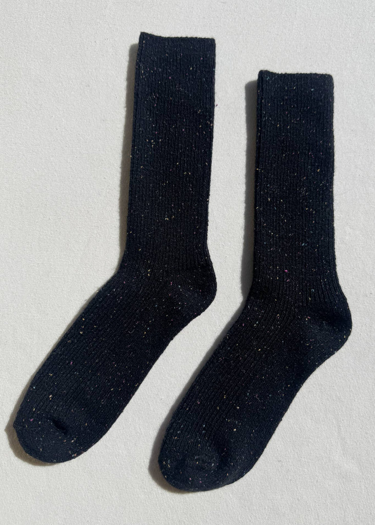 Pair of black socks on a light gray background