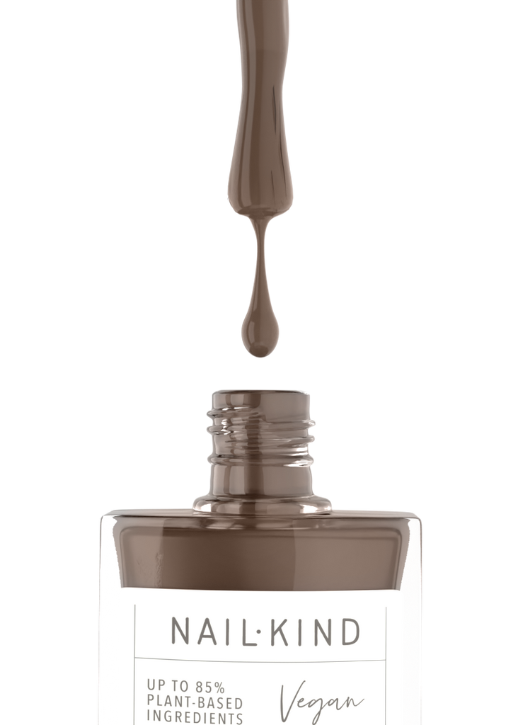 Nail polish bottle with a droplet of brown nail polish on a white background, featuring 'Nail Kind' branding.