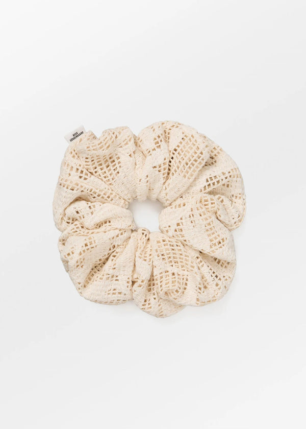 Beige crochet scrunchie on a white background