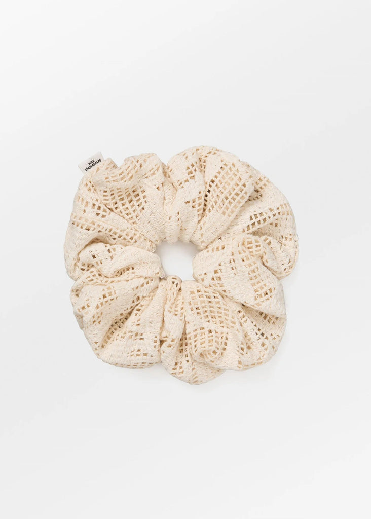 Beige crochet scrunchie on a white background