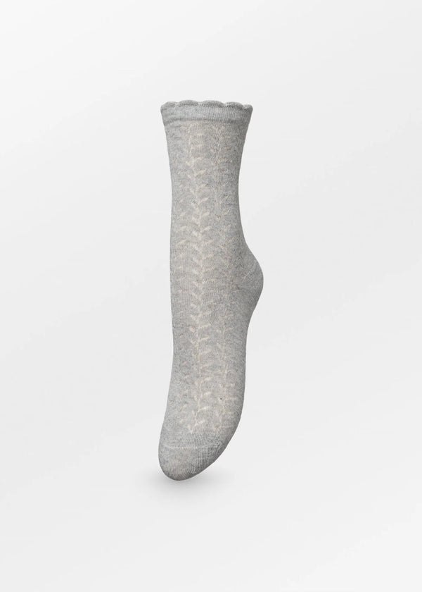 A single light gray knit sock with a subtle chevron pattern, shown floating against a clean white background.