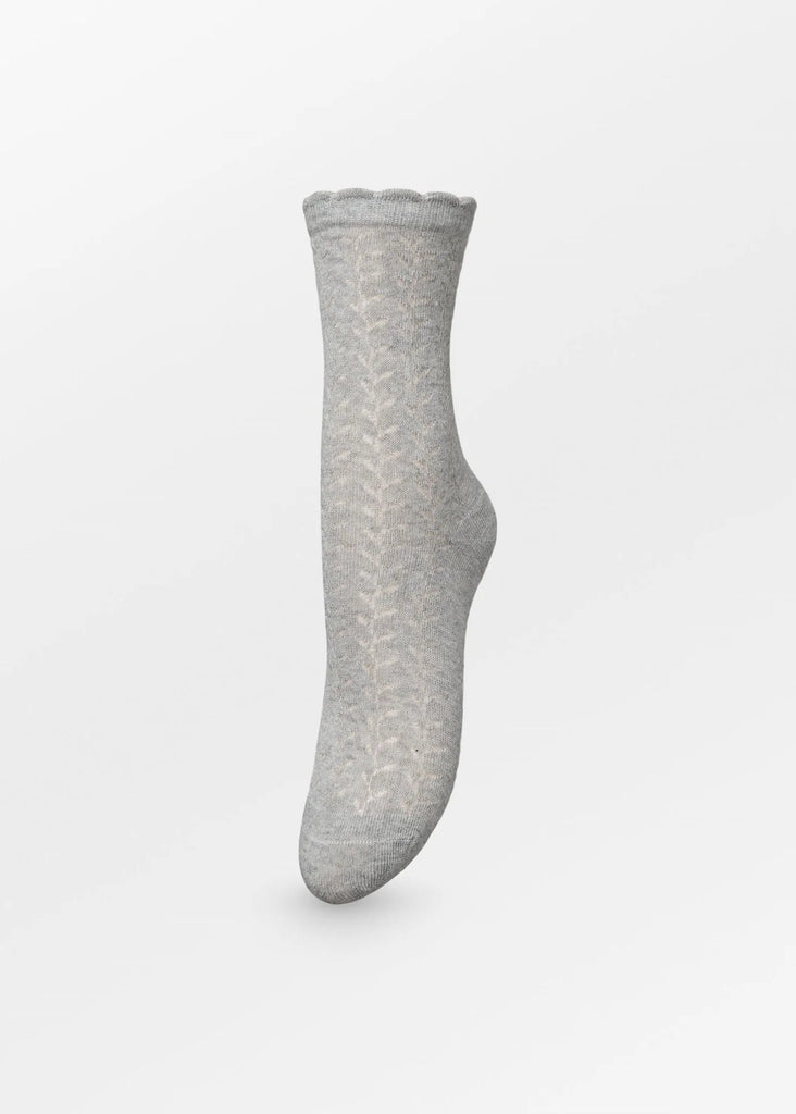 A single light gray knit sock with a subtle chevron pattern, shown floating against a clean white background.