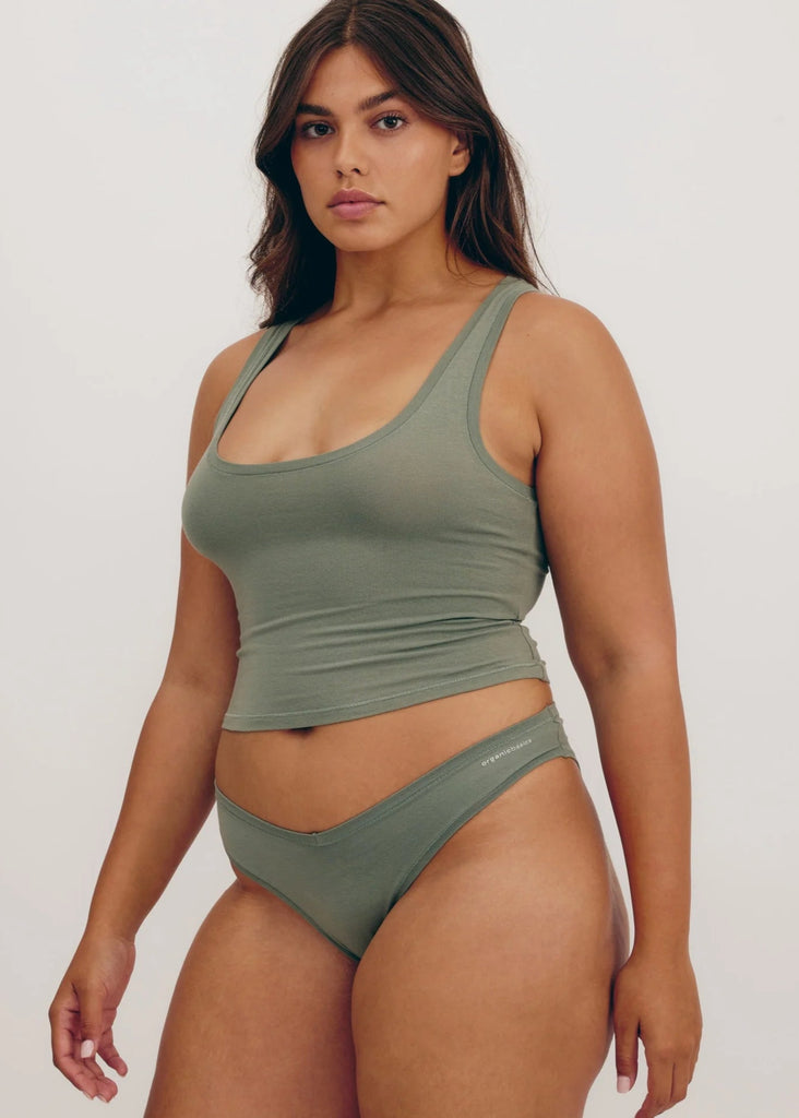 Woman wearing a green bikini against a white background